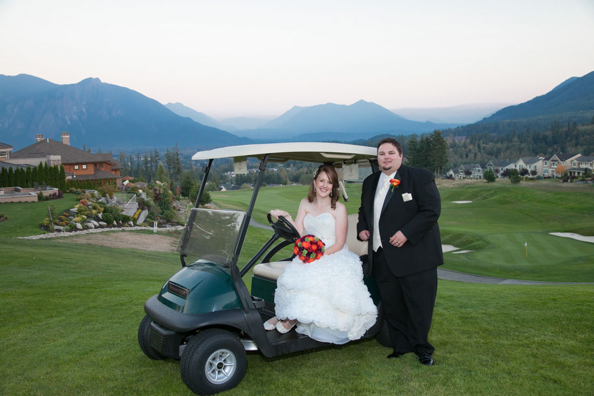 Bride and groom with golf cart, Mt. Si in the background, at Snoqualmie Ridge