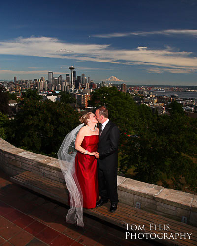 Couple kissing at Kerry Park in Seattle, backdrop of Seattle Center and Mt Rainierr