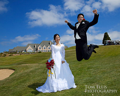 Groom leaping in air with bride at Newcastle Golf Club in Bellevue WA